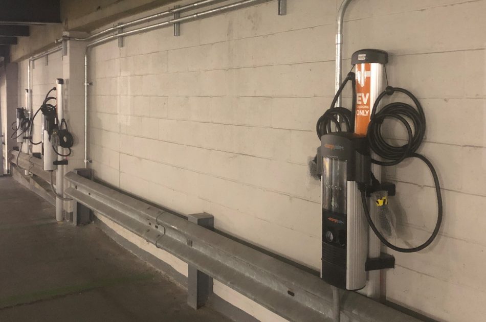 An electric vehicle charging station in a parking garage.